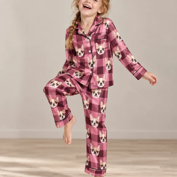 Girl posing in kids plaid pajamas, cream French bulldog faces on pink plaid satin — MyDogPics