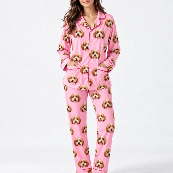 Woman wearing long sleeve pajamas covered in doodle puppy faces on pink fabric with contrast piping — MyDogPics