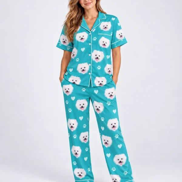 Woman wearing matching couple pajamas covered in white Pomeranian faces on teal satin with hearts and paw prints — MyDogPics