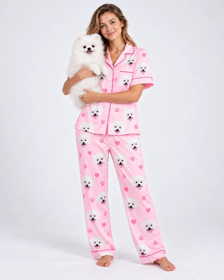Woman in matching couple pajamas holding her Pomeranian up toward the camera — MyDogPics
