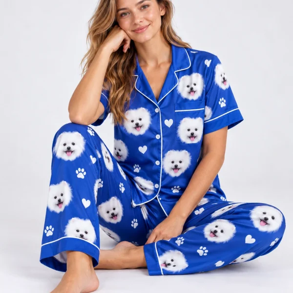 Woman sitting in matching couple pajamas covered in white Pomeranian faces — MyDogPics