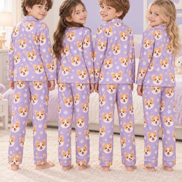 Kids wearing matching kids pajamas with corgi faces on lavender satin with paw prints — MyDogPics