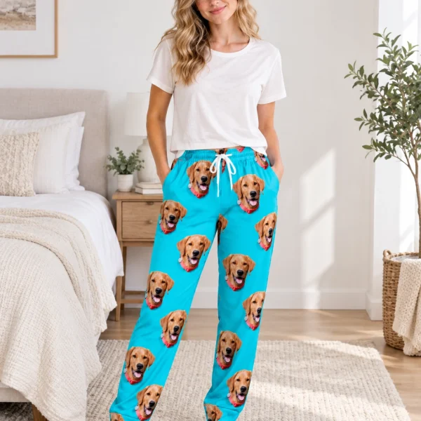 Woman wearing matching pajama pants covered in golden retriever faces on teal fabric — MyDogPics