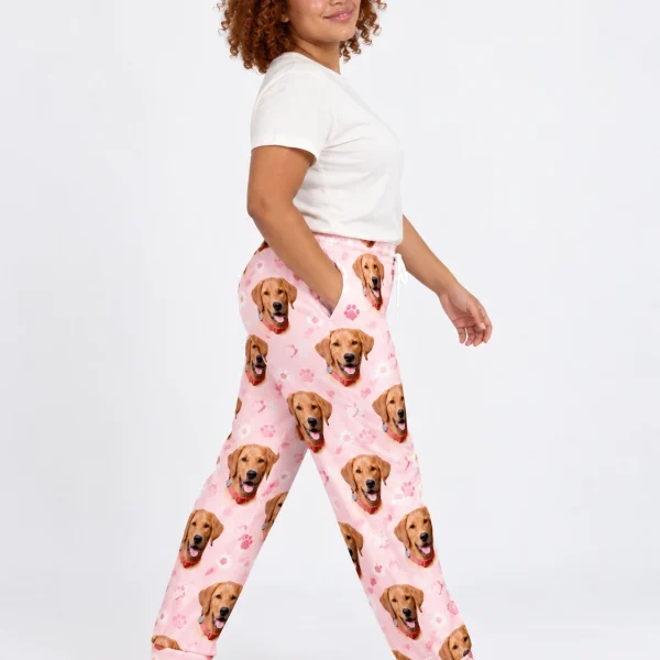 Side view of matching pajama pants with golden retriever faces on blush pink paw-print fabric — MyDogPics