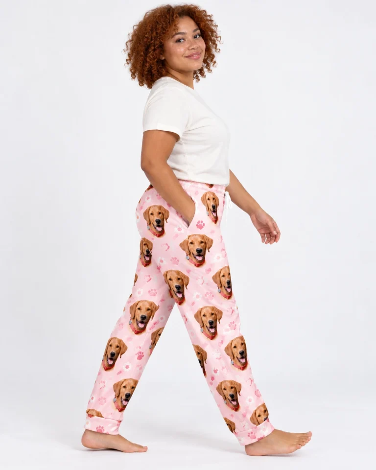 Side view of matching pajama pants with golden retriever faces on blush pink paw-print fabric — MyDogPics
