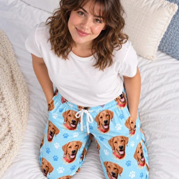 Woman sitting in matching pajama pants covered in golden retriever faces — MyDogPics