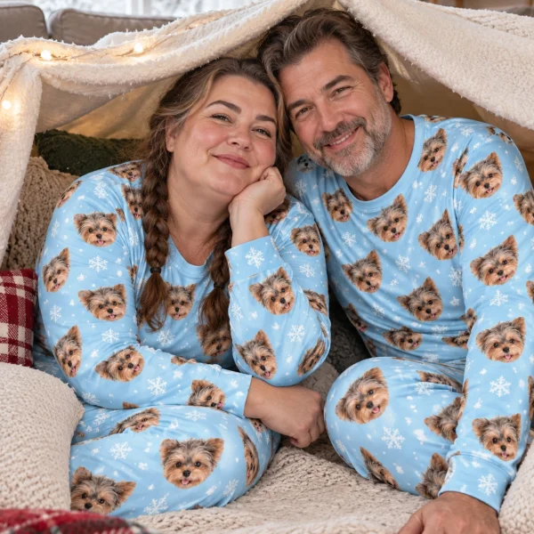Woman and her partner in matching matching pajamas with Yorkshire terrier faces on light blue snowflake fabric — MyDogPics