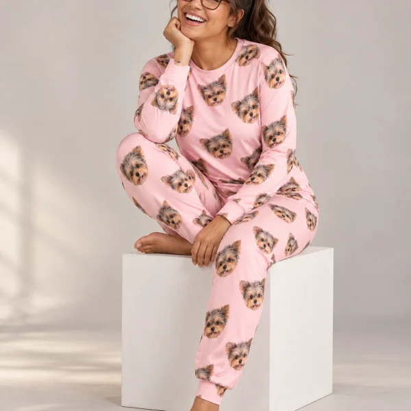 Woman sitting in matching pajamas covered in Yorkshire terrier faces — MyDogPics