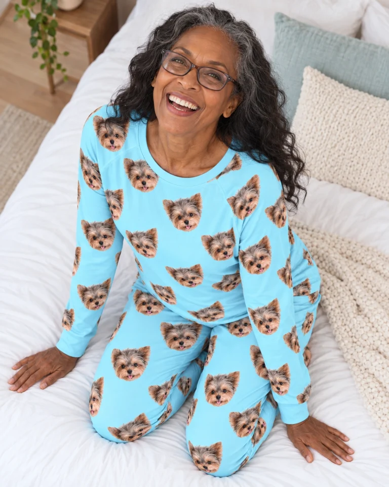 Woman sitting in matching pajamas covered in Yorkshire terrier faces — MyDogPics