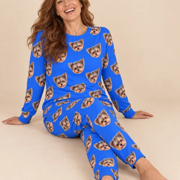 Woman sitting in matching pajamas covered in Yorkshire terrier faces — MyDogPics