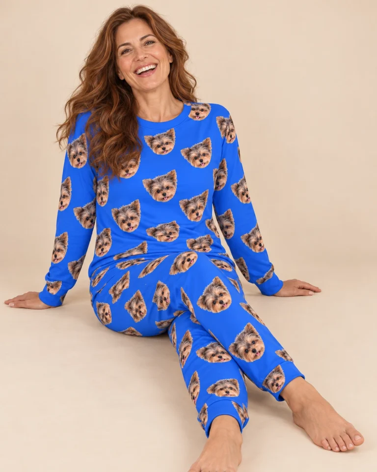 Woman sitting in matching pajamas covered in Yorkshire terrier faces — MyDogPics