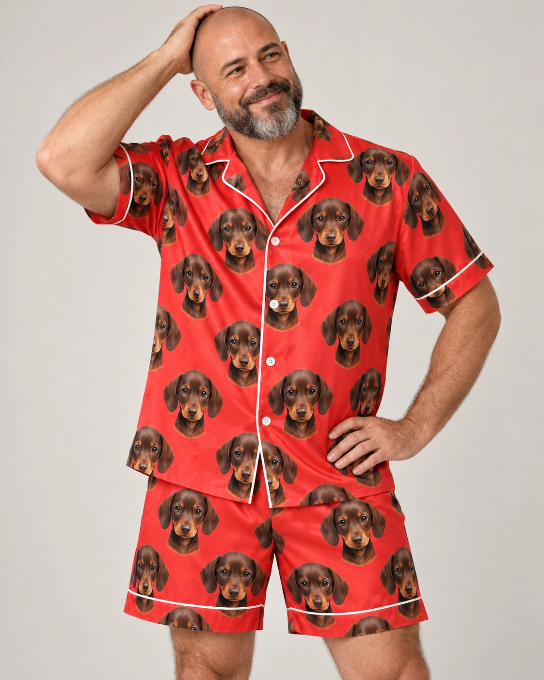 Men’s Festive Pajamas – Front View, Red | MyDogPics Man wearing mens festive pajamas covered in brown dachshund puppy faces on red satin — MyDogPics
