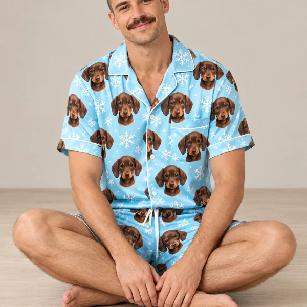 Man sitting in mens festive pajamas covered in brown dachshund puppy faces — MyDogPics