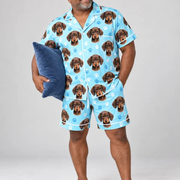 Man wearing a mens pajama set covered in brown dachshund puppy faces on light blue paw-print satin — MyDogPics