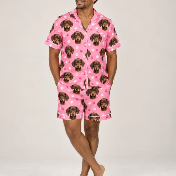 Man wearing a mens pajama set covered in brown dachshund puppy faces on pink paw-print satin — MyDogPics