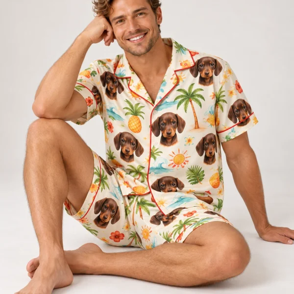 Man sitting in a mens pajama shorts set covered in dachshund faces — MyDogPics