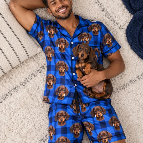 Man in mens pajamas cuddling his dachshund — MyDogPics