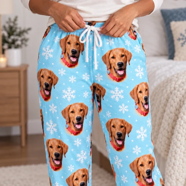 Close-up of the pajama pants women print: golden retriever faces on light blue snowflake fabric — MyDogPics