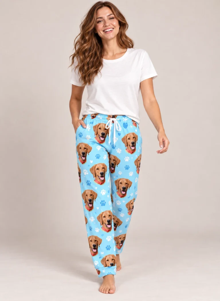 Woman wearing a pajama pants women covered in golden retriever faces on light blue paw-print fabric — MyDogPics
