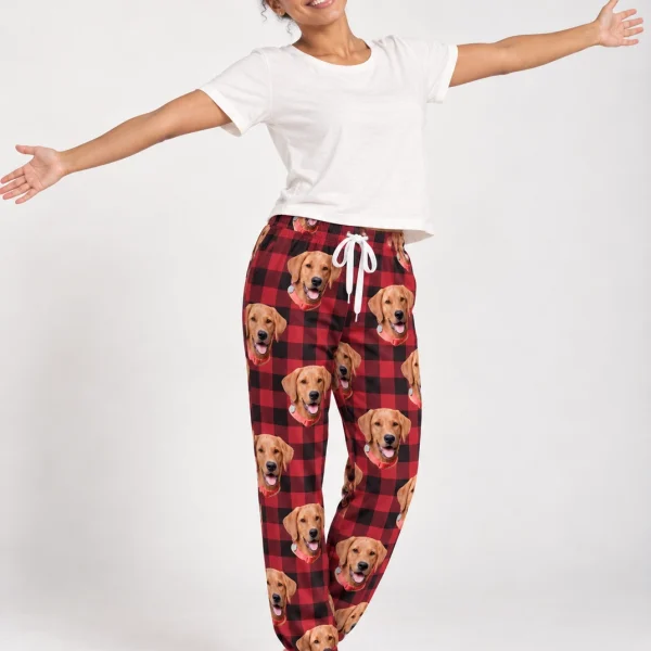Woman wearing a pajama pants women covered in golden retriever faces on red plaid fabric — MyDogPics