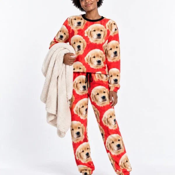 Woman wearing a pajama sets for women covered in golden retriever puppy faces on red fabric — MyDogPics