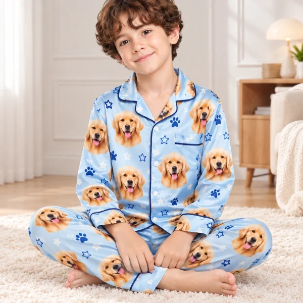 Boy sitting in a personalized pajamas for kids covered in golden retriever faces — MyDogPics