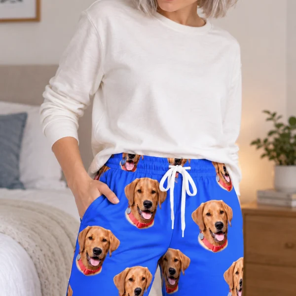 Close-up of the pink pajama pants print: golden retriever faces on royal blue fabric — MyDogPics