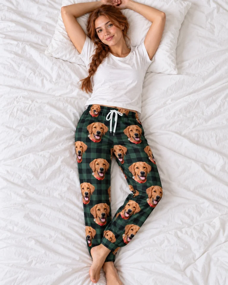Woman posing in pink pajama pants, golden retriever faces on green plaid fabric — MyDogPics