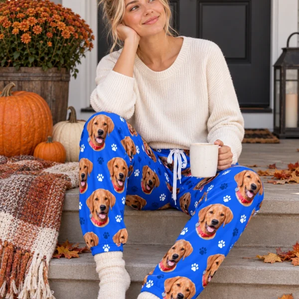 Woman sitting in pink pajama pants covered in golden retriever faces — MyDogPics