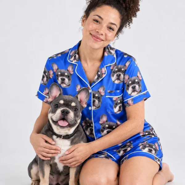 Woman in pink satin pajamas cuddling her French bulldog — MyDogPics