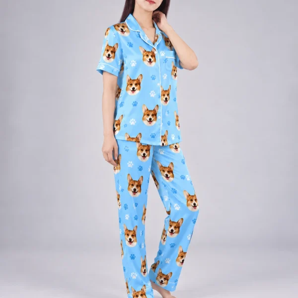 Side view of PJs with dogs on them with corgi faces on sky blue satin with paw prints — MyDogPics