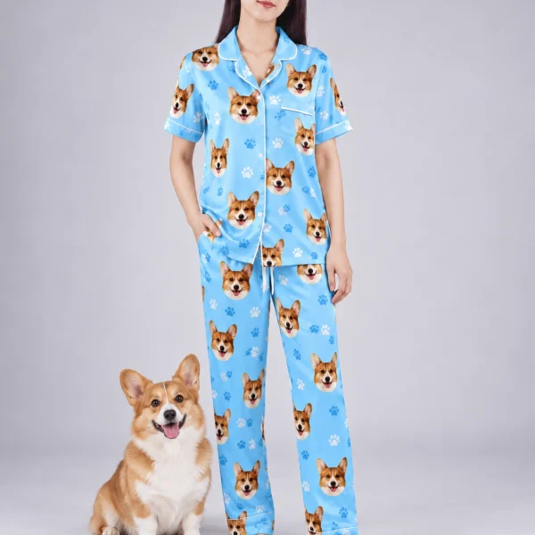Woman in PJs with dogs on them standing next to her corgi — MyDogPics