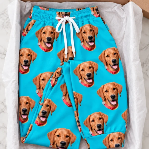 Flat lay of plaid pajama pants: pants covered in golden retriever faces — MyDogPics