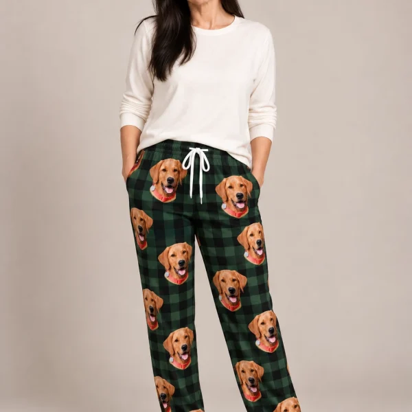 Woman wearing plaid pajama pants covered in golden retriever faces on green plaid fabric — MyDogPics