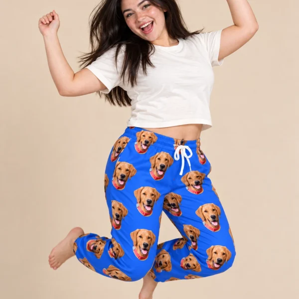 Woman posing in plaid pajama pants, golden retriever faces on royal blue fabric — MyDogPics