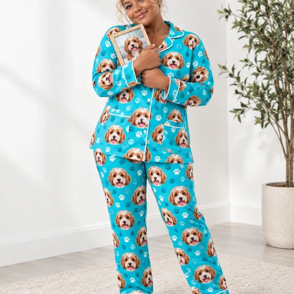 Woman wearing plus size pajamas covered in doodle puppy faces on teal paw-print fabric with contrast piping — MyDogPics