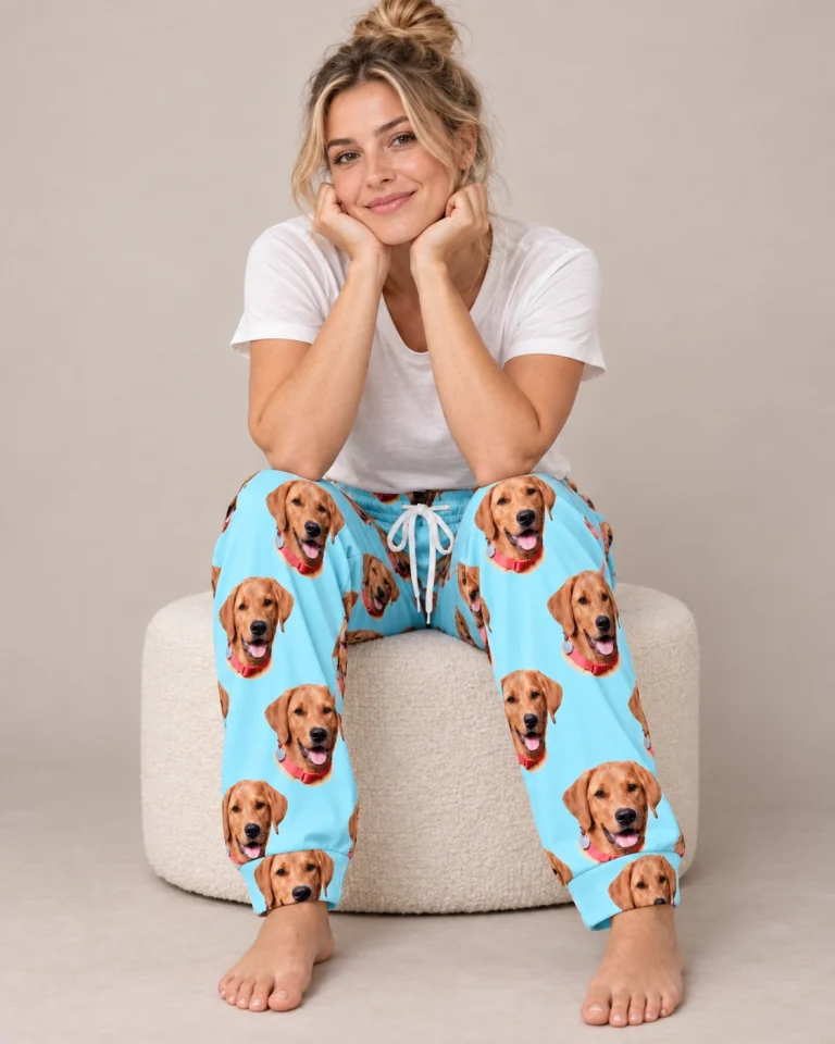 Woman sitting in red pajama pants covered in golden retriever faces — MyDogPics