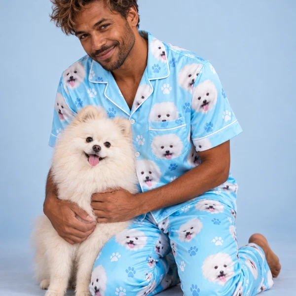 Man in red satin pajamas cuddling his Pomeranian — MyDogPics