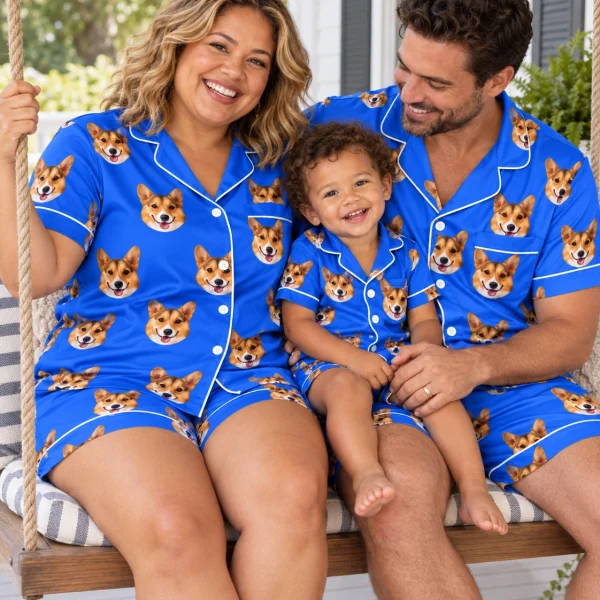 Woman and family in matching satin pajamas for women with tan-and-white corgi faces on royal blue satin — MyDogPics