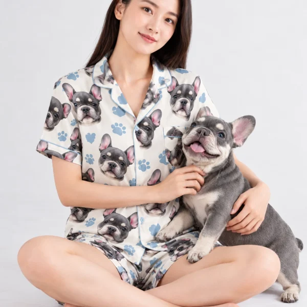 Woman in a satin short pajama set cuddling her French bulldog — MyDogPics