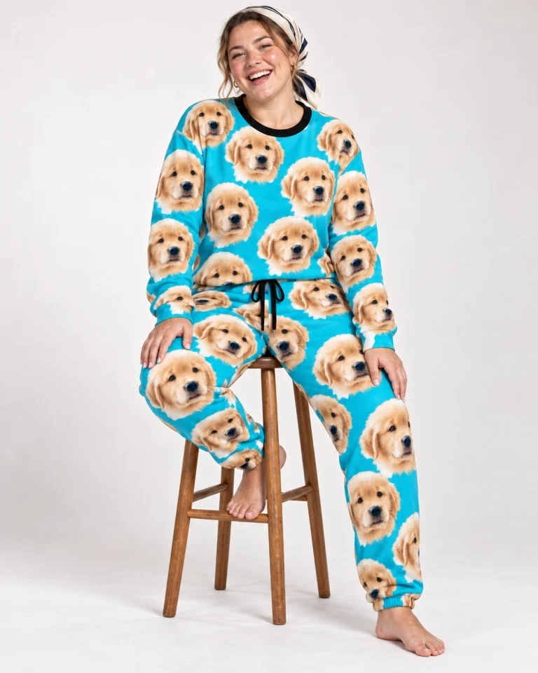 Woman sitting in a soft pajamas for women covered in golden retriever puppy faces — MyDogPics