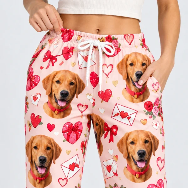 Close-up of the Valentine pajama pants print: golden retriever faces on a pink Valentine hearts print — MyDogPics
