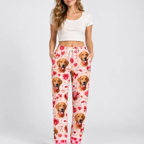 Woman wearing Valentine pajama pants covered in golden retriever faces on a pink Valentine hearts print — MyDogPics