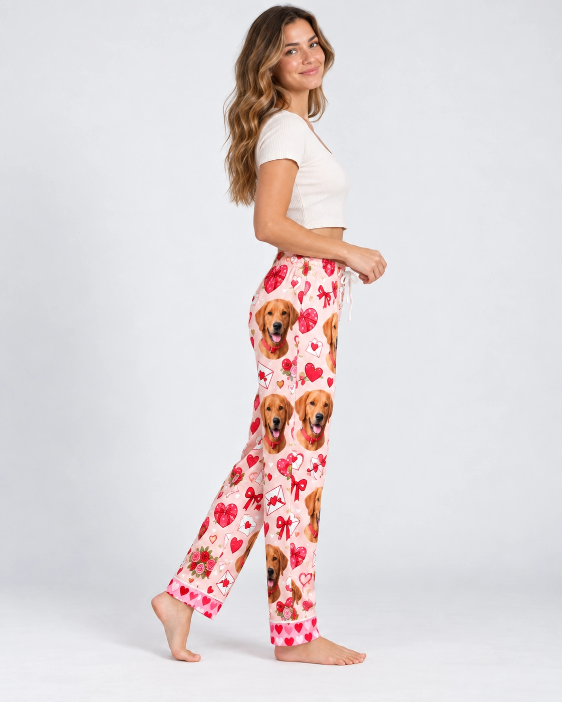 Valentine Pajama Pants – Side View | MyDogPics Side view of Valentine pajama pants with golden retriever faces on a pink Valentine hearts print — MyDogPics