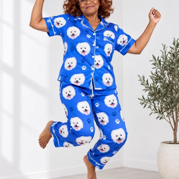 Woman posing in Valentines day pajamas, white Pomeranian faces on royal blue paw-print satin — MyDogPics