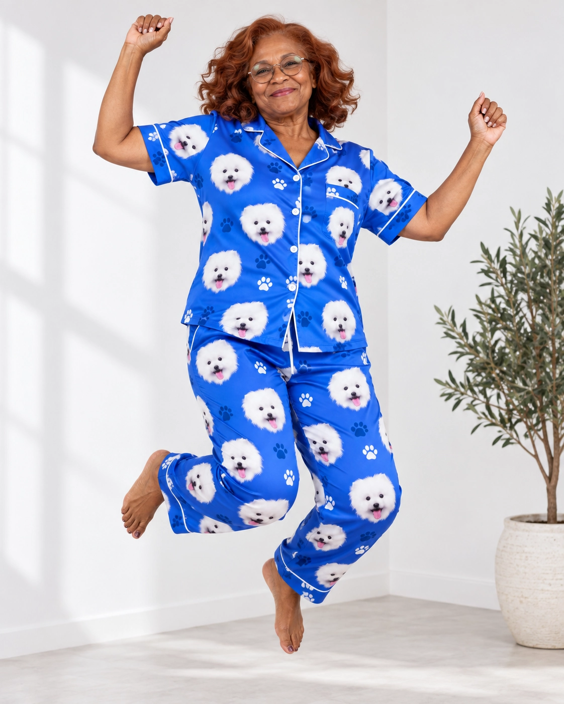 Valentines Day Pajamas – Pose, Royal Blue Paw-Print | MyDogPics Woman posing in Valentines day pajamas, white Pomeranian faces on royal blue paw-print satin — MyDogPics