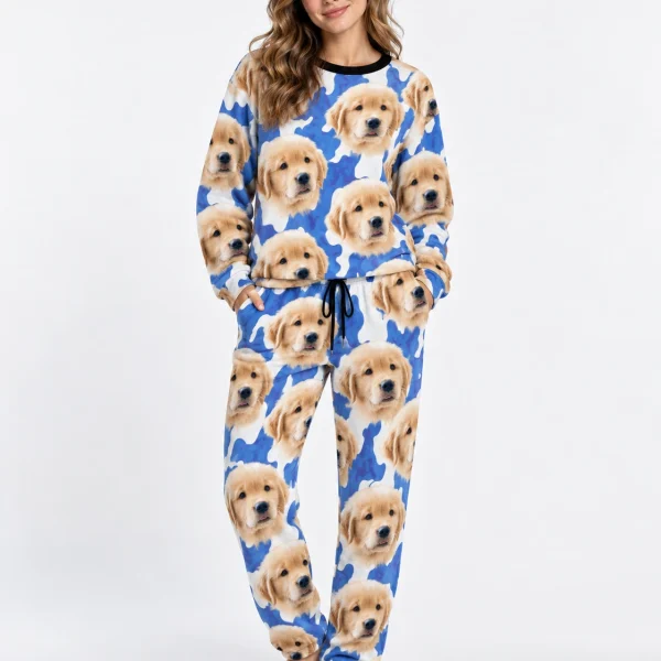Woman wearing warm pajamas covered in golden retriever puppy faces on a blue and white spot print — MyDogPics