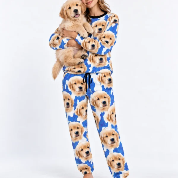 Woman in warm pajamas holding her golden retriever puppy — MyDogPics