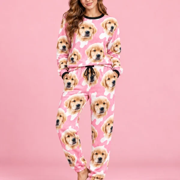 Woman posing in warm pajamas, golden retriever puppy faces on a pink and white spot print — MyDogPics