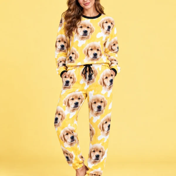 Woman posing in warm pajamas, golden retriever puppy faces on a yellow and white spot print — MyDogPics